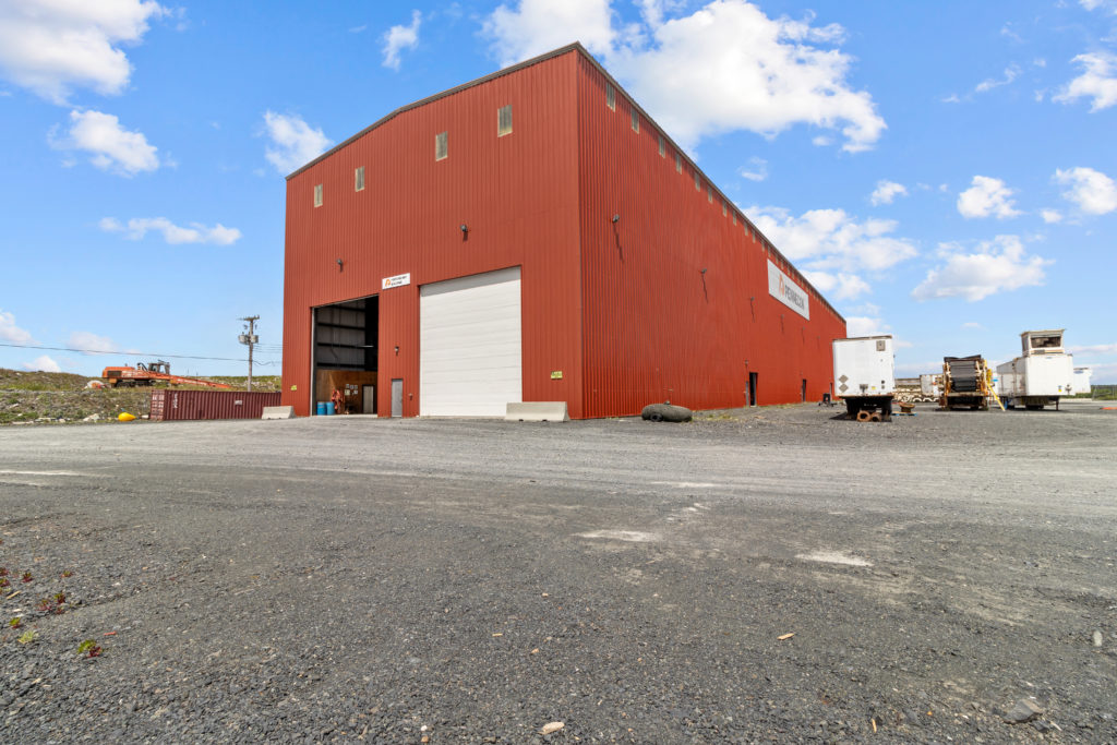 Large indsutrial warehouse with loading doors and yard space